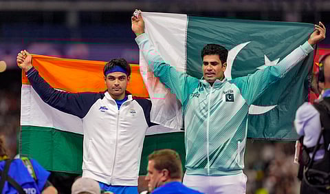 Silver medallist India's Neeraj Chopra and Gold medallist Pakistan's Arshad Nadeem celebrate after the men's javelin throw final at the 2024 Summer Olympics, in Paris, France, Thursday, Aug. 8, 2024.