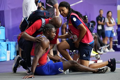 Noah Lyles, of the United States, is treated by medical staff following the men' 200-meters final at the 2024 Summer Olympics, Thursday, August 8, 2024.