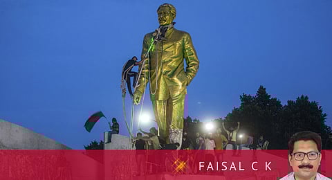 Protesters try to demolish a large statue of Sheikh Mujibur Rahman in Dhaka, Bangladesh, on Monday, Aug. 5, 2024.
