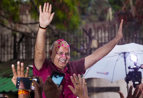 AAP leader Manish Sisodia greets supporters after his release from Tihar jail following his bail granted by the Supreme Court in corruption.