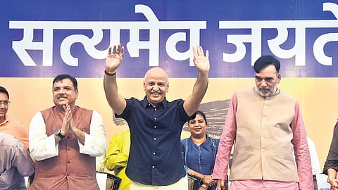 AAP leaders Sanjay Singh, Gopal Rai and Atishi celebrate Manish Sisodia’s release from Tihar jail on bail at a party office in New Delhi on Saturday.