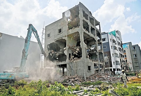 Demolition of an illegal under-construction building underway at Shivarampally in Hyderabad on Saturday