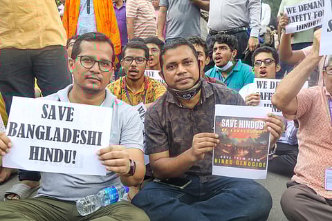 Bangladesh Hindu community members participate in a protest and block the Shahbagh intersection in Dhaka, Bangladesh.