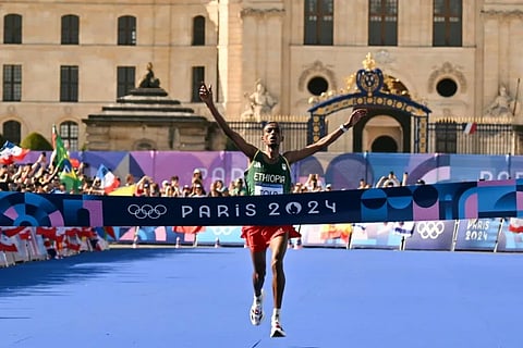 Ethiopia's Tamirat Tola crosses the finish line to win the men's marathon