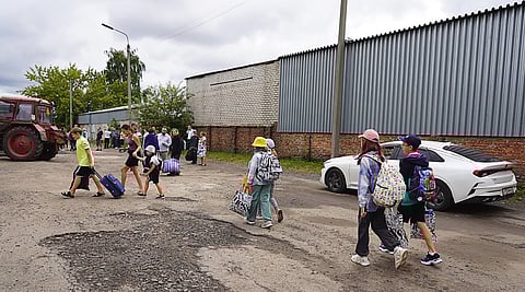 Photograph taken and released by the Government of Kursk region of Russia shows children being evacuated from the town of Rylsk in Kursk region.