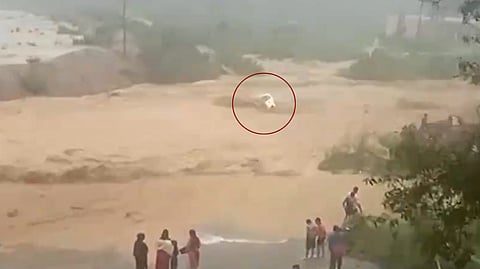 Vehicle got swept away by the flooded rivulet.