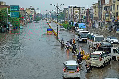 Vehicles pass through a waterlogged Sikar Road following heavy monsoon rains