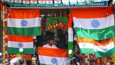 A worker at a flag shop ahead of Independence Day celebration