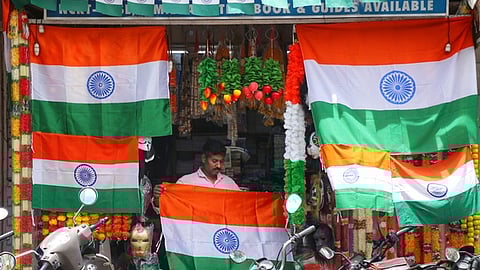 A worker arranges India's national flag for sale, ahead of the country's Independence Day