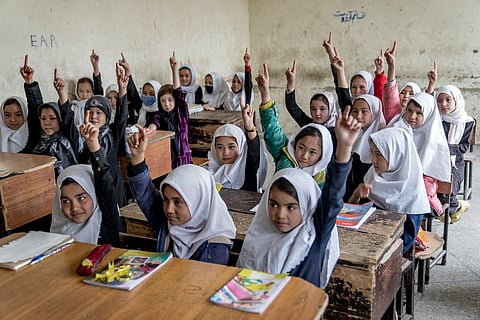 Afghan school girls attend their classroom on the first day of the new school year, in Kabul, Saturday, March 25, 2023.