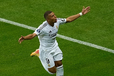 Real Madrid's Kylian Mbappe celebrates after scoring his side's second goal during the UEFA Super Cup Final soccer match between Real Madrid and Atalanta at the Narodowy stadium in Warsaw, Poland, Wednesday, Aug. 14, 2024.