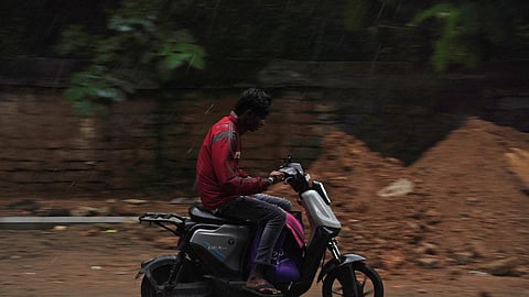 A gig worker seen navigating during heavy rain in Bengaluru