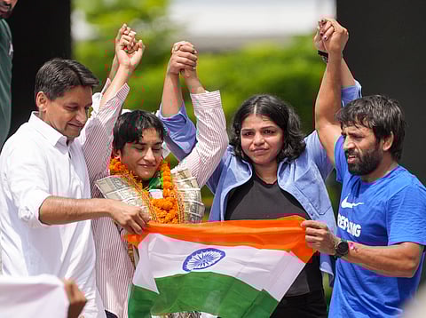 Wrestler Vinesh Phogat with wrestlers Bajrang Punia, Sakshi Malik and Congress MP Deepender Singh Hooda poses for photos on her arrival after Paris Olympics heartbreak, at IGI airport, in New Delhi, Saturday, Aug. 17, 2024.