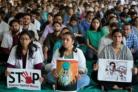 Medical students holds placards during a protest against the rape and killing of a trainee doctor at a government hospital in Kolkata last week, in Ahmedabad, Saturday, Aug. 17, 2024.