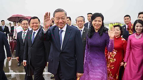 Vietnamese President To Lam, centre left, waves as he arrives in Guangzhou, south China's Guangdong Province, as he starts his three-day official visit to China, Sunday, Aug. 18, 2024.