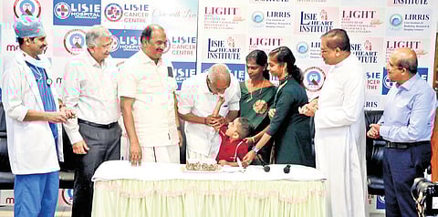 Shivan and his family celebrating 10th year of heart transplant with minister K N Balagopal, Dr Jose Chacko, Fr Paul Karedan and others