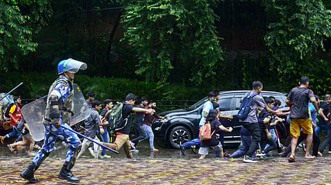 Rapid Action Force (RAF) personnel disperse Mohun Bagan and East Bengal supporters protesting against the alleged rape and murder of RG Kar Hospital doctor, at Salt Lake Stadium in Kolkata.