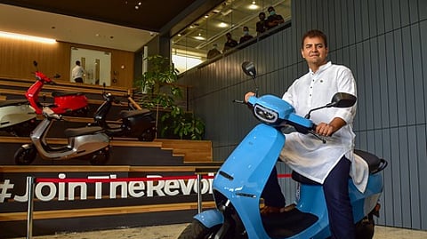 Bengaluru: Ola founder and CEO Bhavish Aggarwal poses with newly launched OLA E-Scooter at a launch press conference in Bengaluru, Sunday, Aug. 15,