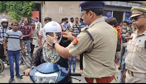DCP (Traffic) Yamuna Prasad gifting a free helmet to a woman rider