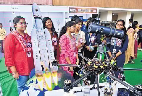 Students take a look at the telescope which is kept for display as a part of National Science Day celebrations at Tummalapalli Kalashetram.