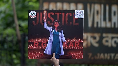 A placard held by a doctor during a protest over the alleged sexual assault and murder of a postgraduate trainee doctor, at Jantar Mantar, in New Delhi.
