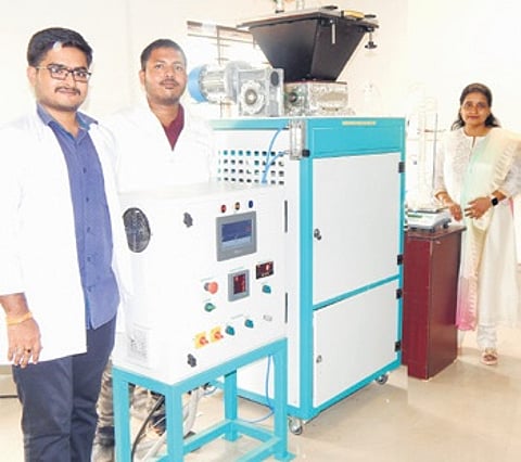 The researchers alongside the reactor