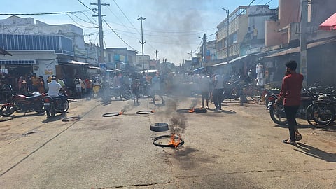 Irate locals placed the body of a deceased person who died consuming spurious liquor, on road and sat on protest demanding compensation at Chikiti in Ganjam on Wednesday