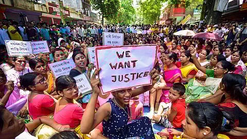 Locals protest against an alleged gang-rape of a 14-year-old girl by three men at Dhing area, in Nagaon district, Friday, Aug. 23, 2024.