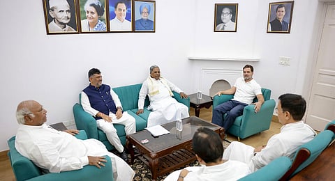 AICC chief Mallikarjun Kharge, LoP in Lok Sabha Rahul Gandhi in conversation with CM Siddaramaiah and DyCM DK Shivakumar in New Delhi on Friday. AICC general secretaries KC Venugopal and Randeep Singh Surjewala look on.