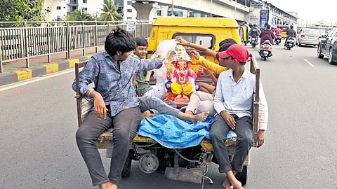 An idol of Ganesha being ferried in an auto in Hyderabad