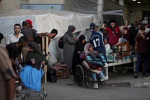 Patients and families move outside the Al-Aqsa Martyrs Hospital in Deir al Balah, Gaza Strip, Sunday, Aug. 25, 2024.