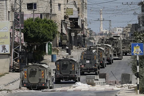 A column of Israeli Army armored vehicles leave following a military operation in the West Bank town of Tubas, Wednesday, Aug 14, 2024.