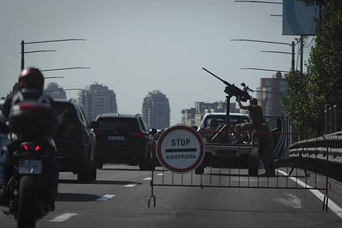Ukranian soldiers guard the sky with a machine-gun on a city road during one of Russian most massive missile and drone attack against Ukraine's energy objects in Kyiv, Ukraine, Monday, Aug 26, 2024.