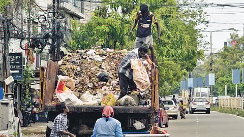 Kudumbashree workers loading waste to trucks near Kaloor