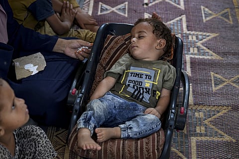 Displaced infant Abdel-Rahman Abu El-Jedian, who suffers from polio sleeps at a makeshift tent camp in Deir al-Balah, central Gaza Strip, Tuesday, August 27, 2024.
