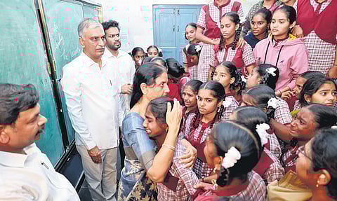 Former minister P Sabitha Indra Reddy consoles a student of the KGBV, Palamakula in Rangareddy district on Saturday while her party colleague T Harish Rao looks on