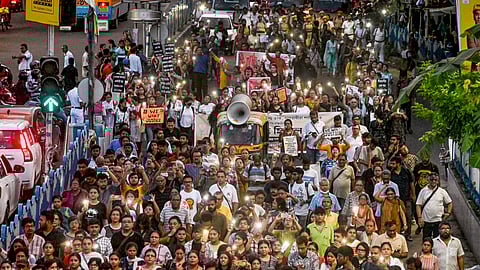 People take part in a protest march against the alleged sexual assault and murder of a trainee doctor, in Kolkata, Saturday,