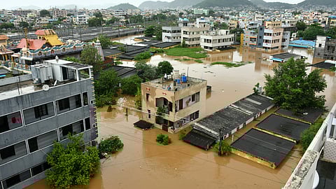 Houses at the Singh Nagar in Vijayawada inundated in flood water after the Budameru canal breaches on Sunday.
