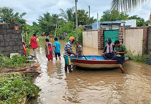 People are seen shifted to a relief center from the flood-affected areas in Manuguru on Sunday