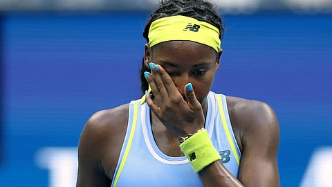 USA's Coco Gauff wipes her face after losing her women's singles round of 16 tennis match against USA's Emma Navarro on day seven of the US Open tennis tournament on September 1, 2024.