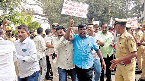 Police detain BBMP contractors, who were on a protest seeking immediate release of their pending dues, in Bengaluru on Monday