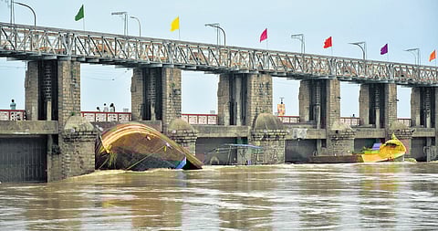 A pillar at gate no. 69 of Prakasam Barrage was damaged after boats which came in floodwater got struck