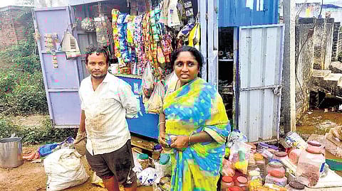 Residents of Saradhinagar clean their shop after floodwaters recede in Khammam on Monday