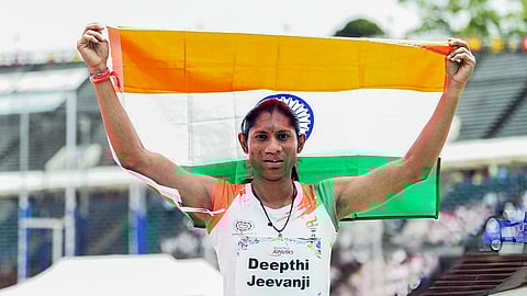 Indian para-athlete Deepthi Jeevanji poses with the national flag.