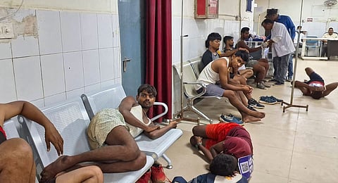 Youths, who came for a recruitment rally, lie on the ground of a hospital while receiving treatment, in Palamu on Sept. 2, 2024.