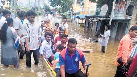 Members of the Canoeing and Kayaking Association of Andhra Pradesh rescue flood victims in Vijayawada