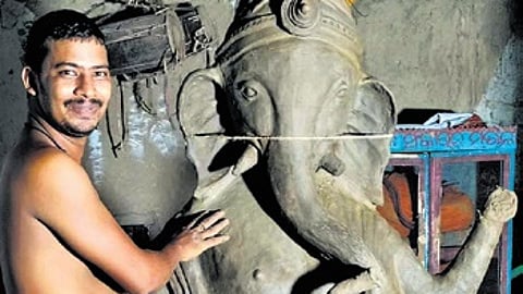 An artisan carving an idol of Lord Ganesh at Kumbharsahi