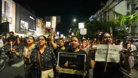 People during a candlelight march in protest against the alleged rape and murder of a trainee woman doctor at the RG Kar Medical College and Hospital.