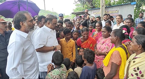 Ministers Gottipati Ravikumar and Anagani Satya Prasad interacting with people in flood-affected village Bobbarlanka in Bapatla district on Wednesday