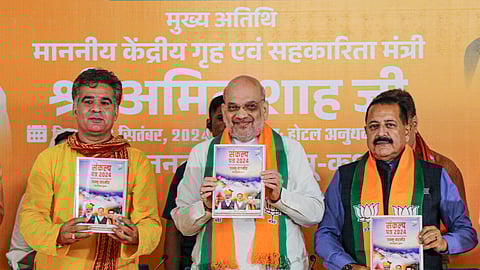 Home Minister Amit Shah, MoS Jitendra Singh and Jammu and Kashmir BJP President Ravinder Raina during the release of BJP's election manifesto ahead of the state Assembly elections, in Jammu, Friday, Sept 6, 2024.